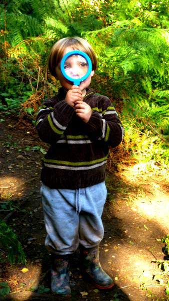 Child with magnifying glass