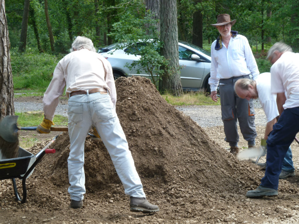 Volunteers load wheelbarrows