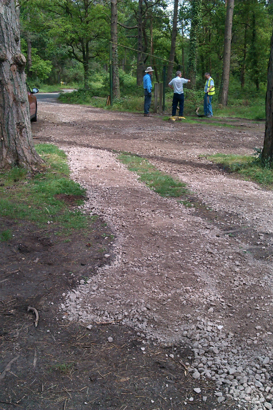 Volunteers check re-installed sign